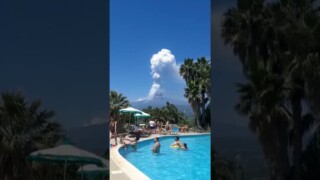 Mount Etna erupts while people enjoy a swim in nearby city Giardini Naxos Mount Etna erupts while people enjoy a swim in nearby city Giardini Naxos